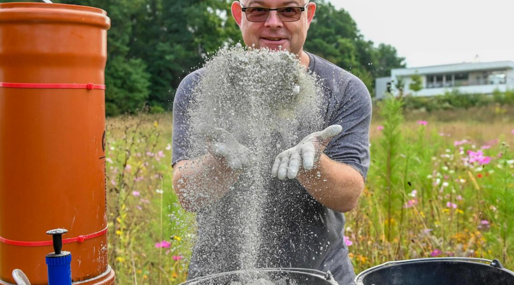 Photo: Man playfully throwing rock dust